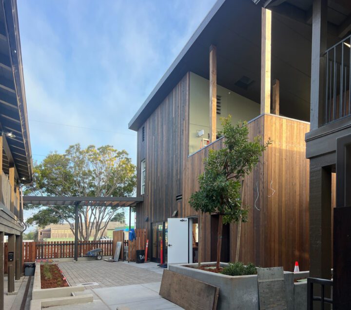 Mother Bernard House, motel conversion, landscaped courtyard entrance — VMWP