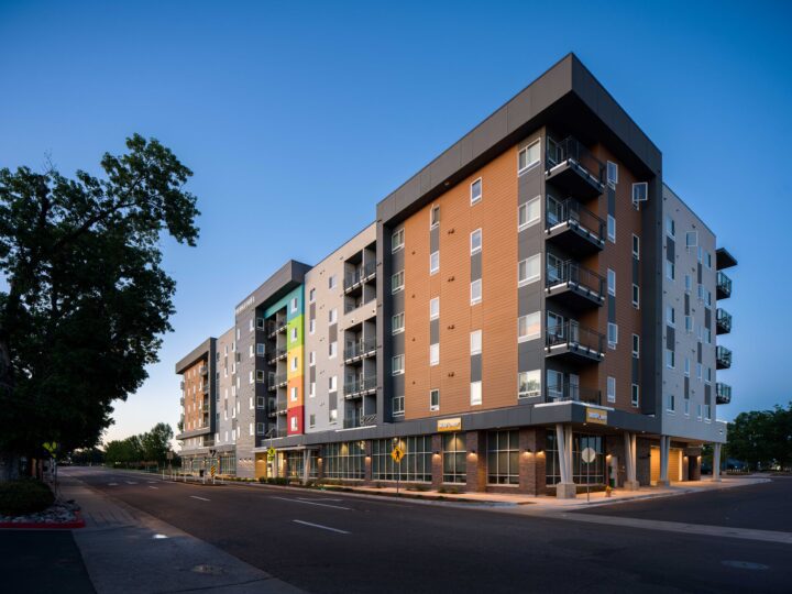 Affordable Housing Atop Mixed-Use Community Montbello FreshLo Hub Denver dusk corner shot — Image: Matt Staver