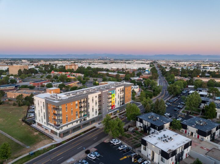 Affordable Housing Atop Mixed-Use Community Montbello FreshLo Hub Denver dusk aerial — Image: Matt Staver