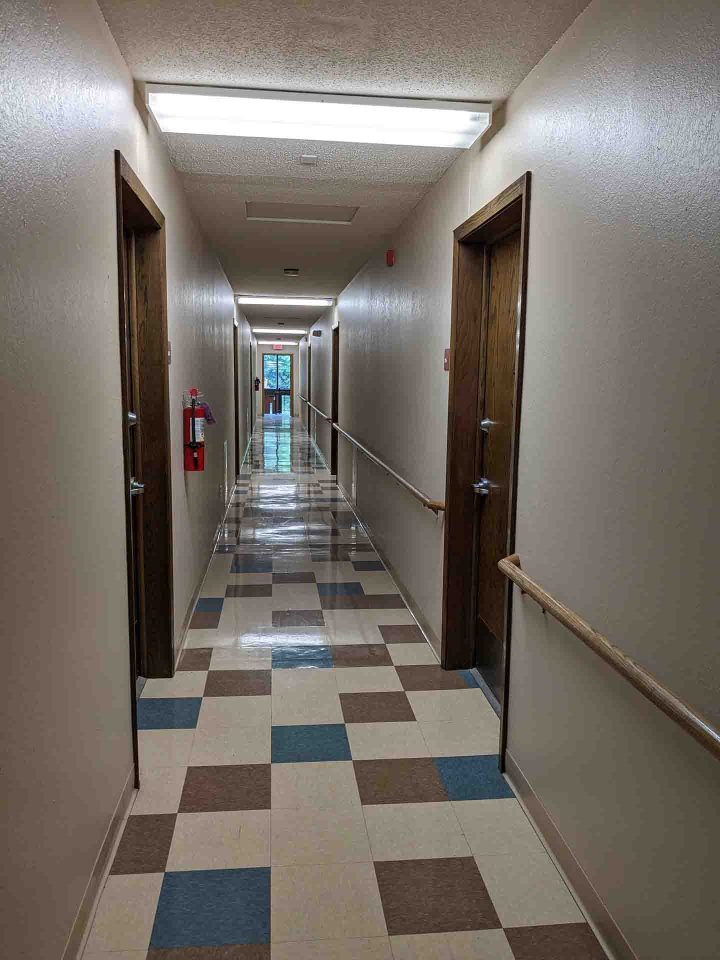 BEFORE Maple Hills Apartments Renovation Minneapolis corridor — Image: VMWP