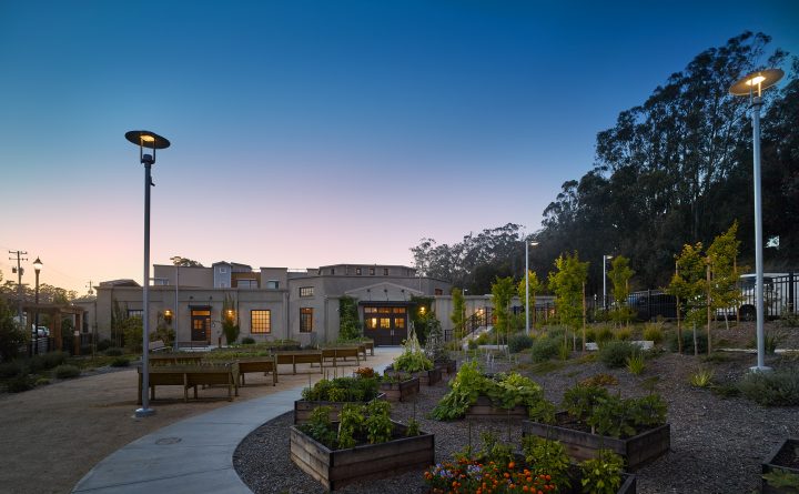 Veterans Village, veterans affordable housing, landscaped courtyard at dusk — VMWP